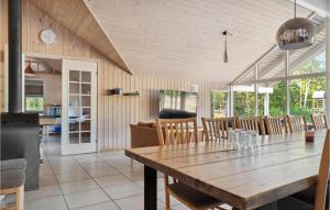 a dining room with a wooden table and chairs at Lovely Home In Rødby With Kitchen in Rødby