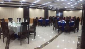 a dining room with blue tables and chairs at Favanhmai Hotel in Phonsavan