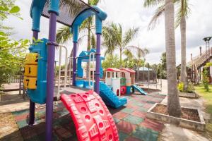 a playground at a park with palm trees at Baan Kiangnam Pattaya Resort in Ban Pong
