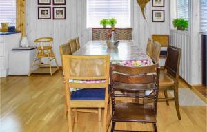 a dining room with a wooden table and chairs at Five-Bedroom Holiday Home In Vikesa in Hovland