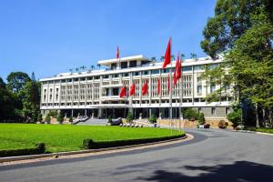 a building with red flags in front of a road at Laverne Hotel in Ho Chi Minh City