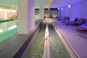 a swimming pool with lounge chairs next to a swimming pool at Hotel Parco Smeraldo Terme in Ischia