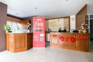 a kitchen with a red sign in the middle of a room at Purada Mansion in Si Racha