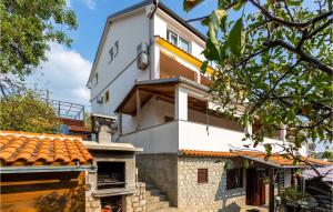 a white house with an orange roof at Gorgeous Apartment In Omisalj With Wifi in Omišalj