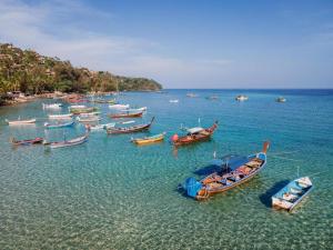 a group of boats sitting in the water at OYO 259 Baan Napatr in Ban Thalat Choeng Thale
