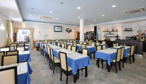 a dining room with blue tables and chairs at Dom Fernando I in Loulé