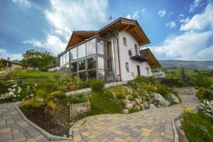 a house on a hill with a pathway leading to it at B&B Ambrosia in Aosta