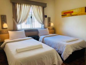 Postel nebo postele na pokoji v ubytování Baguio Holiday Villas