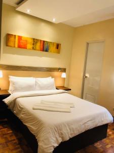 Postel nebo postele na pokoji v ubytování Baguio Holiday Villas