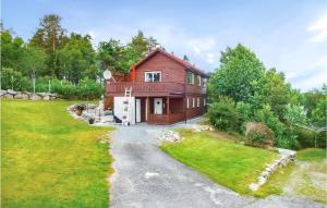 a house with a gravel driveway in front of it at Awesome Home In Kolnes in Eike