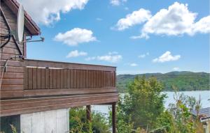 a deck with a view of a lake at Awesome Home In Kolnes in Eike