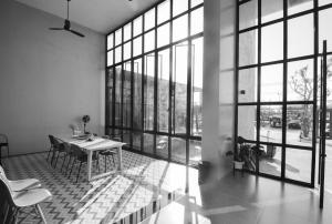 a dining room with a table and large windows at Boondara Boutique Hotel in Nakhon Phanom +58 photos