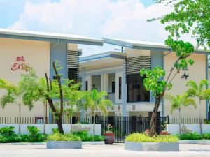 a building with trees in front of it at Segara Residencias Subic Bay in Olongapo