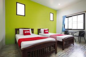 Un ou plusieurs lits dans un hébergement de l'établissement OYO 676 Kradangnga Resort