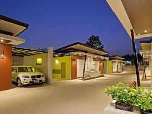a car parked in front of a house at The Rich Resort in Krabi town