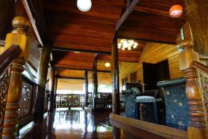 a large room with wooden walls and wooden floors at Capital O923 Elephant at Baan Tawai in Bān Sawan