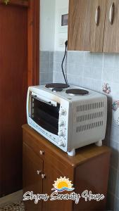 a toaster oven sitting on top of a cabinet at Skyros Serenity House in Skiros +13 photos