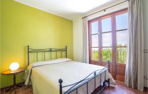 a bedroom with a bed and a large window at Villa 1 in Corsanico-Bargecchia