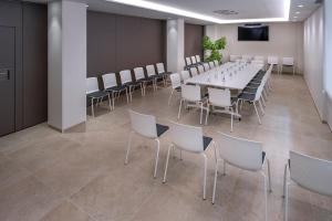 a conference room with a long table and chairs at Hotel Mar Blau in Calella +83 photos