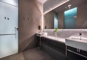 a bathroom with two sinks and a mirror at Coller Boutique Hostel in Singapore