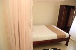 Postel nebo postele na pokoji v ubytování Jatheo Hotel Rwentondo