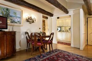 a dining room with a table and chairs at Torre Dell'Orologio Signature Residence in Venice