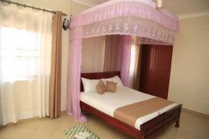 Postel nebo postele na pokoji v ubytování Jatheo Hotel Rwentondo + 16 fotografií