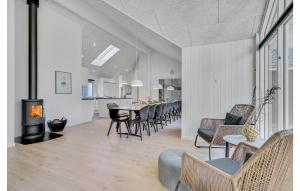 a living room with a table and chairs and a fireplace at Gorgeous Home In Nørre Nebel With Sauna in Nørre Nebel