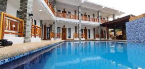 a swimming pool in the middle of a house at Alona Mariners Resort in Panglao