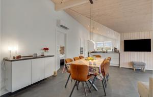 a kitchen and dining room with a table and chairs at Nice Home In Tarm With Sauna in Tarm