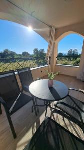 a living room with a table and chairs and a view at Blue harmony 1 Malinska in Malinska