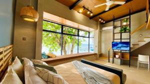 a bedroom with a bed and a television in it at Marzon Beach Resort - Boracay in Boracay