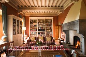 
a living room filled with furniture and a fireplace at Borgo Pignano in Pignano
