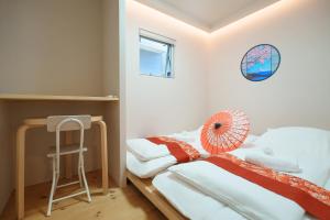 Postel nebo postele na pokoji v ubytování OHAYO Hotel 大森西