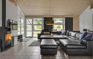 a living room with a couch and a fireplace at Amazing Home In Ebeltoft With Wifi in Ebeltoft