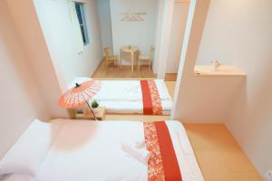 Postel nebo postele na pokoji v ubytování OHAYO Hotel 大森西