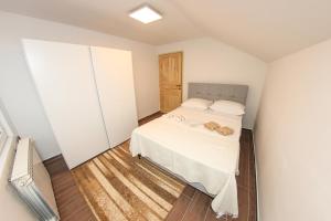 a small bedroom with a bed and a closet at Apartments Villa Begić in Sarajevo
