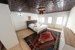 a bedroom with a bed and a rug at Apartments Villa Begić in Sarajevo