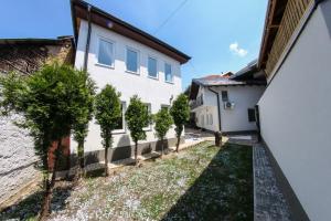 a row of trees in front of a building at Apartments Villa Begić in Sarajevo