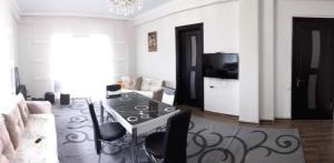 a living room with a table and a couch at Villa Royal Realm in Batumi