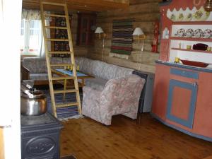 a living room with a couch and a stove at Hytte på fjellet, med mange turmuligheter ! in Gol
