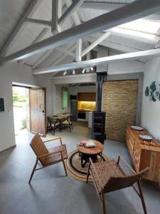 a large living room with a table and chairs at The Cocoon and olives Hut in Koropi