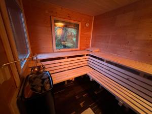 a sauna with a window in a wooden cabin at ALMNEST - LACHTAL in Lachtal +57 photos