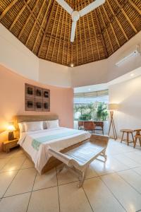 a bedroom with a large bed with a wooden ceiling at Villa Coccoos II Spacious 2BR Pererenan Canggu in Tumbak Bayuh