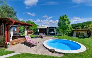 a pool in a yard with two chairs and a table at Amazing Home In Lopatinec With Jacuzzi in Lopatinec