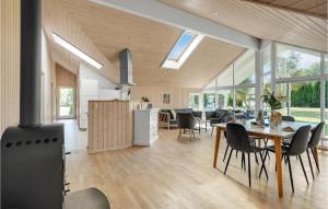 a kitchen and dining room with a table and chairs at Holiday Home Bæverstien V in Marielyst