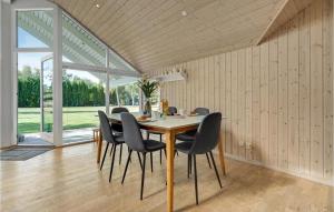 a dining room with a table and chairs at Holiday Home Bæverstien V in Marielyst