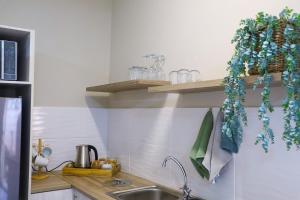a kitchen with a sink and a counter top at Milk & Honey Guesthouse in Kimberley +47 photos
