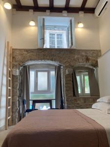 a bedroom with a large bed and two windows at studio apartment Vicelic in Dubrovnik
