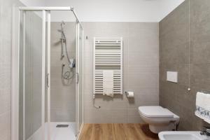 a bathroom with a shower and a toilet and a sink at Antica Pusterla Maison de Charme in Vicenza +19 photos